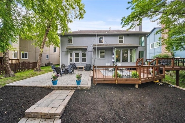 8102 W 153rd St, Overland Park, KS 66223 - rear view of property featuring a wooden deck, a patio, central AC, and a chimney