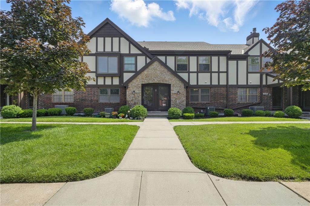 10547 Foster St, Overland Park, KS 66212 - view of front of home featuring a front yard, a chimney, and french doors