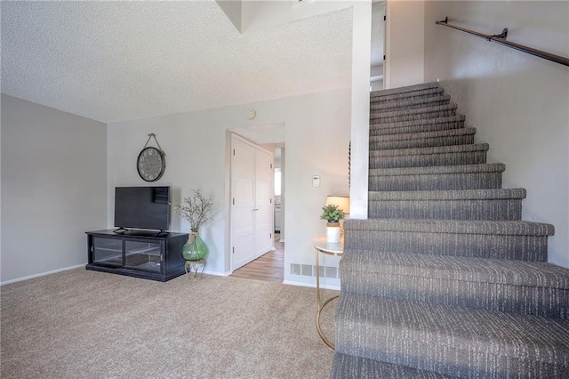 2406 Alabama St Unit 9D, Lawrence, KS 66046 - stairs with carpet flooring and a textured ceiling