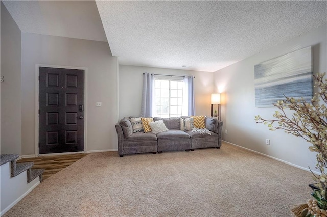 2406 Alabama St Unit 9D, Lawrence, KS 66046 - living area featuring carpet flooring, a textured ceiling, and stairway