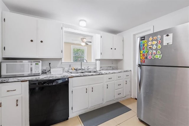 8700 Independence Ave, Kansas City, MO 64125 - kitchen with freestanding refrigerator, dishwasher, white microwave, a sink, and light countertops