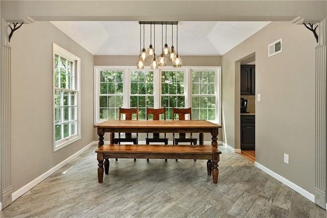 8 Apache Dr, Lake Winnebago, MO 64034 - dining area featuring healthy amount of natural light, light wood-style flooring, baseboards, and vaulted ceiling