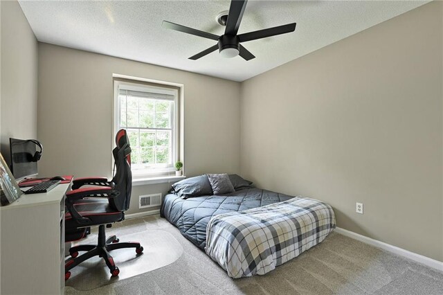 8 Apache Dr, Lake Winnebago, MO 64034 - bedroom with an office area, carpet flooring, a textured ceiling, baseboards, and a ceiling fan