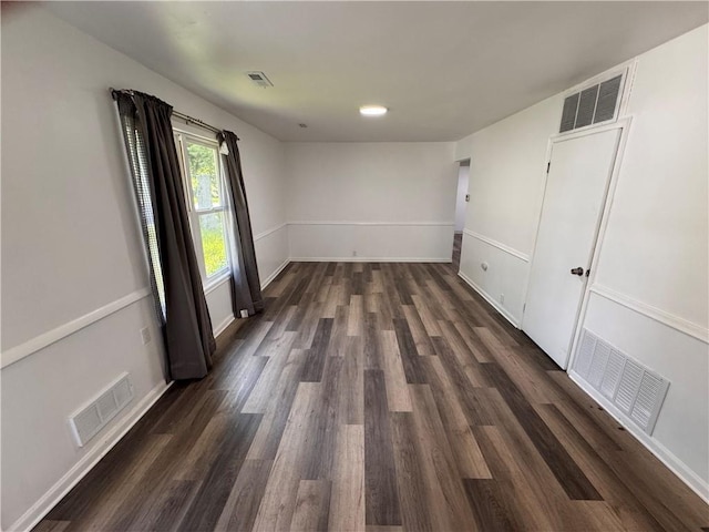 7703 E 107th St, Kansas City, MO 64134 - unfurnished bedroom featuring dark wood-style flooring and baseboards