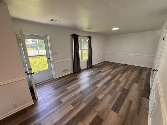 7703 E 107th St, Kansas City, MO 64134 - empty room with dark wood-style flooring and baseboards