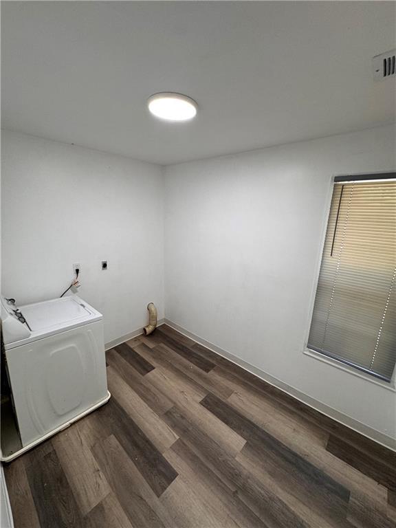 7703 E 107th St, Kansas City, MO 64134 - washroom featuring washer / dryer, wood finished floors, and baseboards