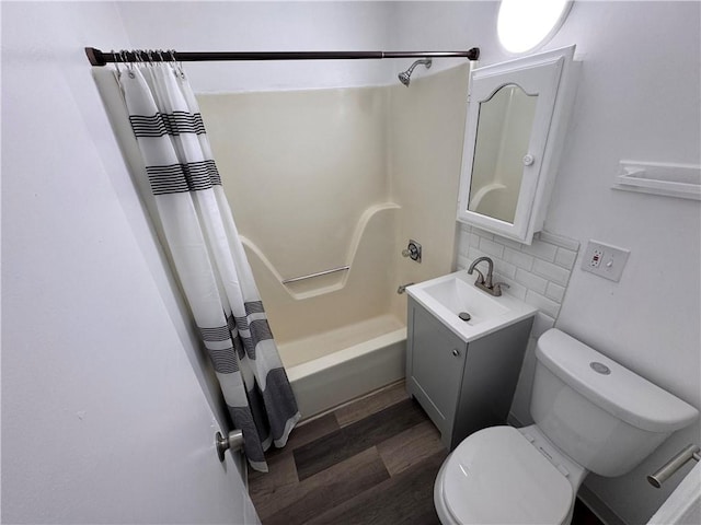 7703 E 107th St, Kansas City, MO 64134 - bathroom featuring shower / tub combo with curtain, vanity, toilet, tasteful backsplash, and wood finished floors