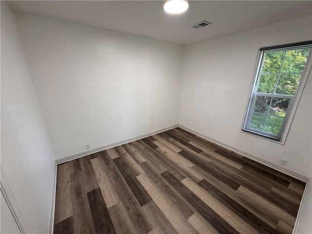 7703 E 107th St, Kansas City, MO 64134 - empty room with dark wood finished floors and baseboards