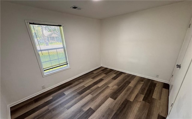 7703 E 107th St, Kansas City, MO 64134 - empty room with dark wood-style floors and baseboards