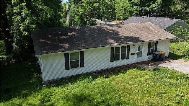 7703 E 107th St, Kansas City, MO 64134 - view of front of property featuring a shingled roof and a front lawn