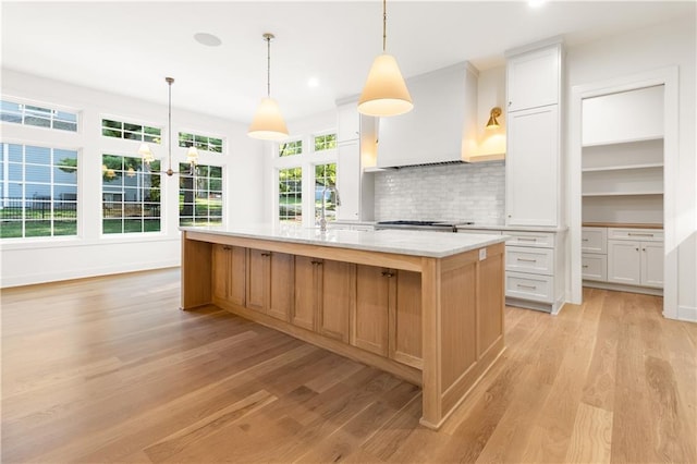 18568 W 180th Ct, Olathe, KS 66062 - kitchen with custom exhaust hood, light wood finished floors, light countertops, a sink, and recessed lighting