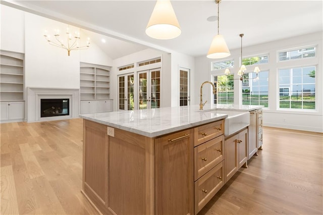 18568 W 180th Ct, Olathe, KS 66062 - kitchen featuring a chandelier, a sink, light wood-style floors, and vaulted ceiling
