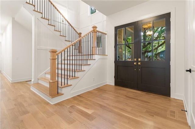 18568 W 180th Ct, Olathe, KS 66062 - entrance foyer featuring french doors, stairs, wood finished floors, baseboards, and a decorative wall