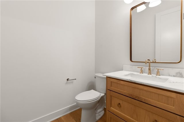 18568 W 180th Ct, Olathe, KS 66062 - bathroom featuring wood finished floors, vanity, toilet, and baseboards