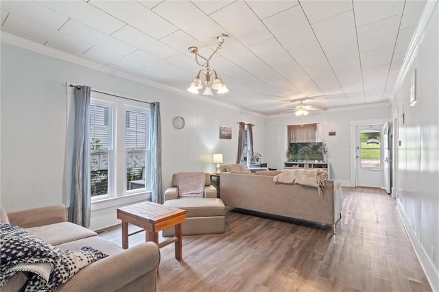 211 S 4th St, Fredonia, KS 66736 - living room featuring ornamental molding, wood finished floors, and a chandelier