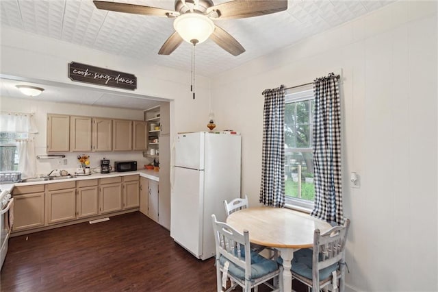 211 S 4th St, Fredonia, KS 66736 - kitchen with freestanding refrigerator, dark wood-type flooring, light countertops, a sink, and black microwave