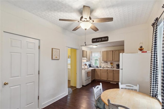 211 S 4th St, Fredonia, KS 66736 - kitchen featuring white appliances, dark wood-type flooring, light countertops, ceiling fan, and under cabinet range hood