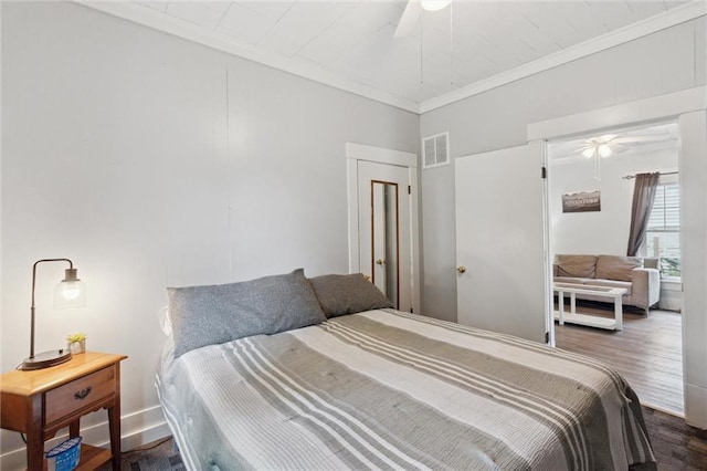 211 S 4th St, Fredonia, KS 66736 - bedroom with wood finished floors, ornamental molding, and a ceiling fan