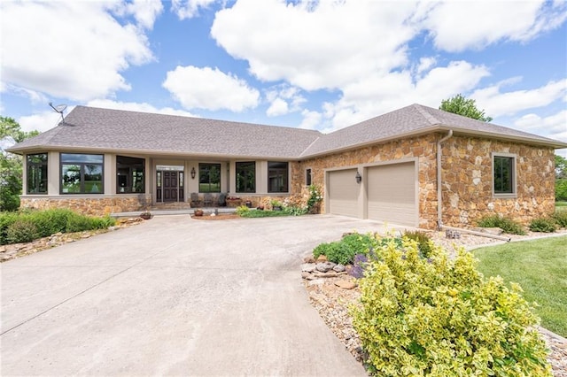 1672 N 1st Rd, Baldwin City, KS 66006 - ranch-style house with stone siding, an attached garage, driveway, and roof with shingles