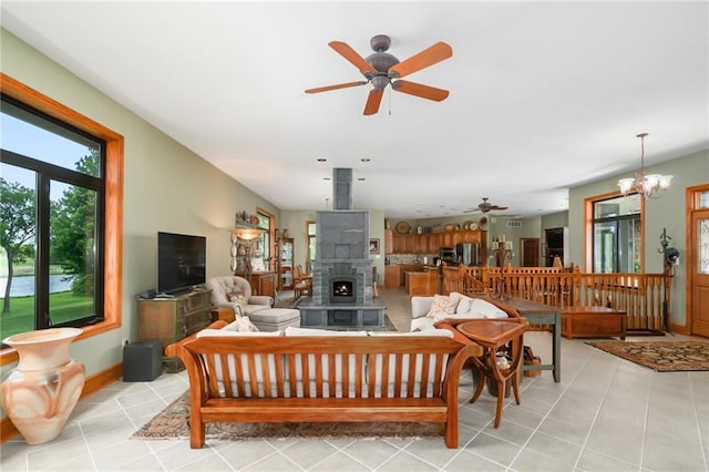 1672 N 1st Rd, Baldwin City, KS 66006 - living room with a ceiling fan, light tile patterned floors, a chandelier, and baseboards