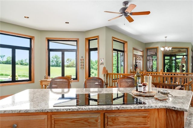 1672 N 1st Rd, Baldwin City, KS 66006 - kitchen featuring black electric cooktop, a ceiling fan, light stone countertops, and hanging light fixtures