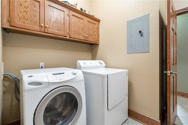 1672 N 1st Rd, Baldwin City, KS 66006 - washroom with electric panel, separate washer and dryer, cabinet space, light tile patterned floors, and baseboards