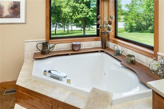1672 N 1st Rd, Baldwin City, KS 66006 - bathroom featuring a whirlpool tub, healthy amount of natural light, a textured wall, and vanity