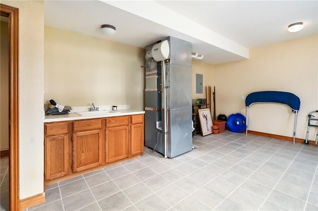 1672 N 1st Rd, Baldwin City, KS 66006 - kitchen featuring a sink, light countertops, brown cabinets, and light tile patterned flooring