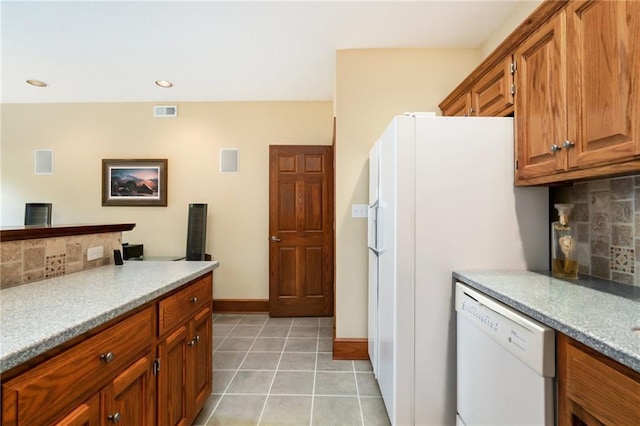 1672 N 1st Rd, Baldwin City, KS 66006 - kitchen featuring white appliances, backsplash, brown cabinetry, light tile patterned floors, and recessed lighting