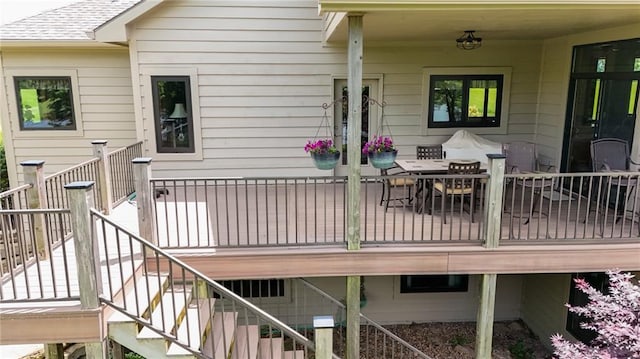 1672 N 1st Rd, Baldwin City, KS 66006 - wooden deck with stairs and outdoor dining space