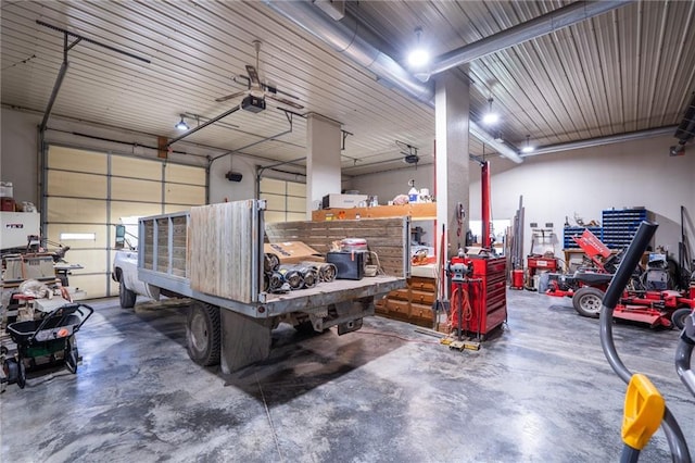 1672 N 1st Rd, Baldwin City, KS 66006 - garage featuring a workshop area, a garage door opener, and ceiling fan