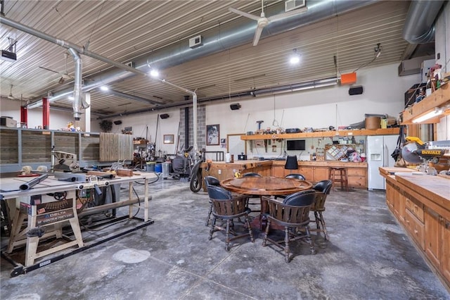 1672 N 1st Rd, Baldwin City, KS 66006 - garage with a workshop area and white refrigerator with ice dispenser