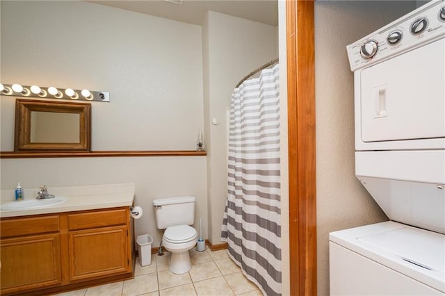 1672 N 1st Rd, Baldwin City, KS 66006 - bathroom with stacked washer / dryer, toilet, vanity, tile patterned flooring, and curtained shower