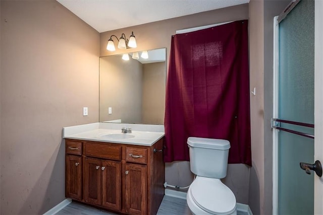 624 Mcdonald Rd, Leavenworth, KS 66048 - bathroom featuring vanity, toilet, baseboards, and wood finished floors