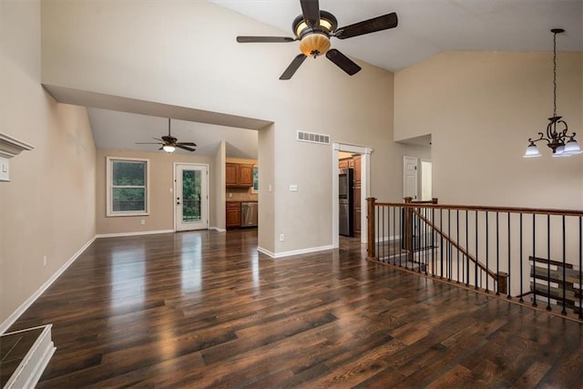 624 Mcdonald Rd, Leavenworth, KS 66048 - unfurnished living room featuring ceiling fan, dark wood-style floors, baseboards, a chandelier, and high vaulted ceiling