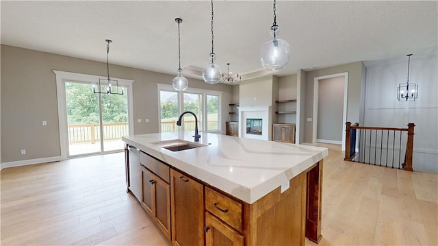 19079 Millstone Ter, Saint Joseph, MO 64505 - kitchen featuring a chandelier, a sink, light wood finished floors, and a textured ceiling