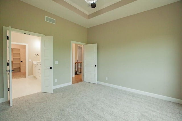 19079 Millstone Ter, Saint Joseph, MO 64505 - unfurnished bedroom featuring carpet flooring, baseboards, a raised ceiling, and a towering ceiling