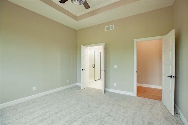 19079 Millstone Ter, Saint Joseph, MO 64505 - unfurnished bedroom with carpet, a tray ceiling, baseboards, and ceiling fan