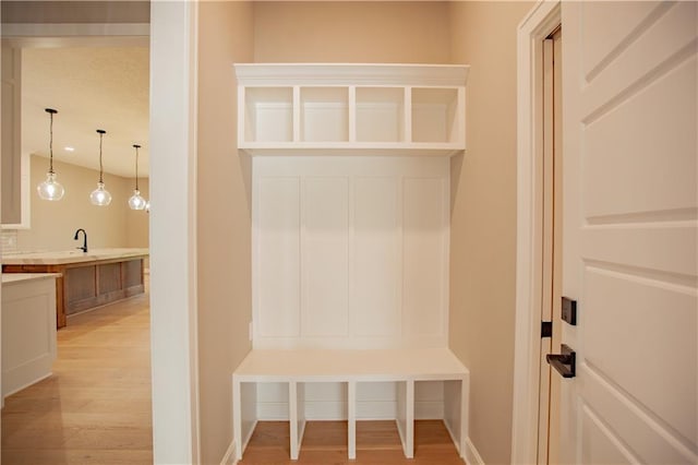 19079 Millstone Ter, Saint Joseph, MO 64505 - mudroom featuring light wood finished floors, a sink, and baseboards