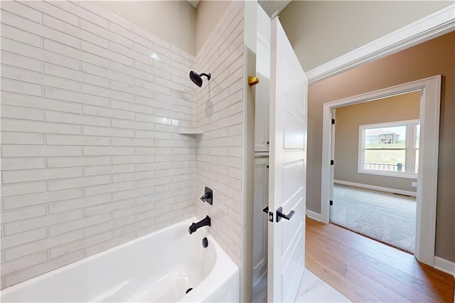 19079 Millstone Ter, Saint Joseph, MO 64505 - bathroom with wood finished floors, shower / bath combination, and baseboards