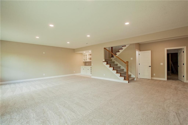 19079 Millstone Ter, Saint Joseph, MO 64505 - below grade area with stairs, light colored carpet, baseboards, and recessed lighting