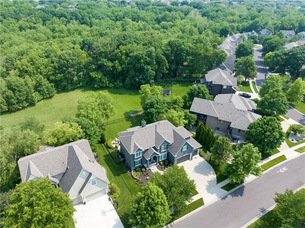 12349 Westgate St, Overland Park, KS 66213 - aerial perspective of suburban area featuring a heavily wooded area
