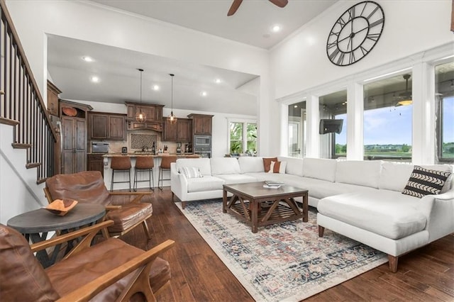 8909 SE 1st St, Blue Springs, MO 64064 - living room with ceiling fan, stairs, dark wood-style floors, recessed lighting, and a high ceiling