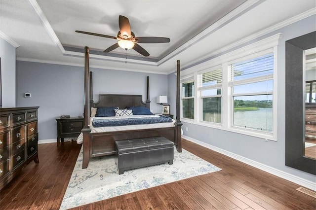 8909 SE 1st St, Blue Springs, MO 64064 - bedroom with a raised ceiling, dark wood-style flooring, baseboards, a ceiling fan, and crown molding