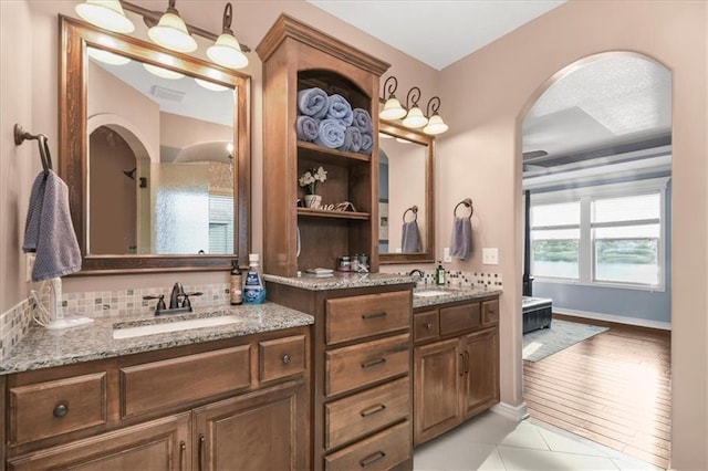 8909 SE 1st St, Blue Springs, MO 64064 - full bathroom with double vanity, tile patterned flooring, and baseboards