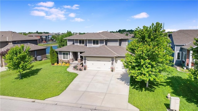 8909 SE 1st St, Blue Springs, MO 64064 - view of front of home with a garage, concrete driveway, a front lawn, stone siding, and a residential view