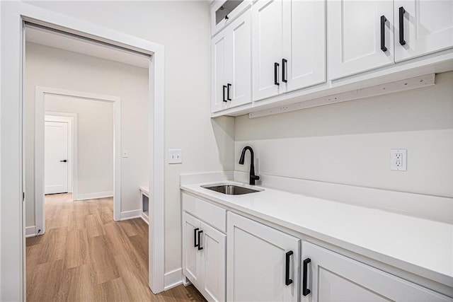 6932 Kenton St, Shawnee, KS 66226 - laundry area featuring a sink and light wood-type flooring