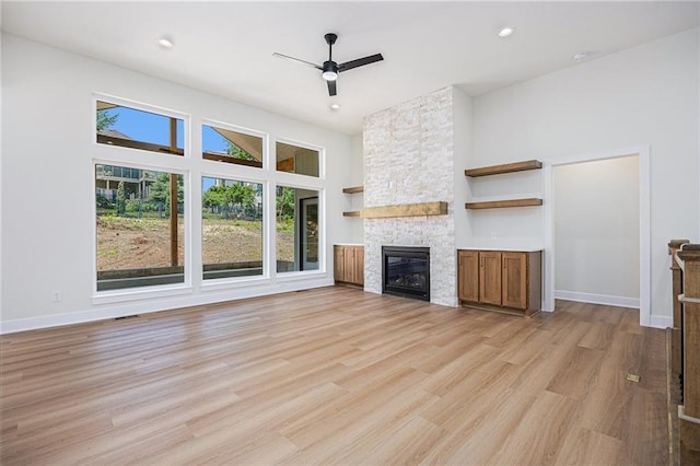 6932 Kenton St, Shawnee, KS 66226 - unfurnished living room with plenty of natural light, a ceiling fan, a fireplace, light wood-style flooring, and recessed lighting