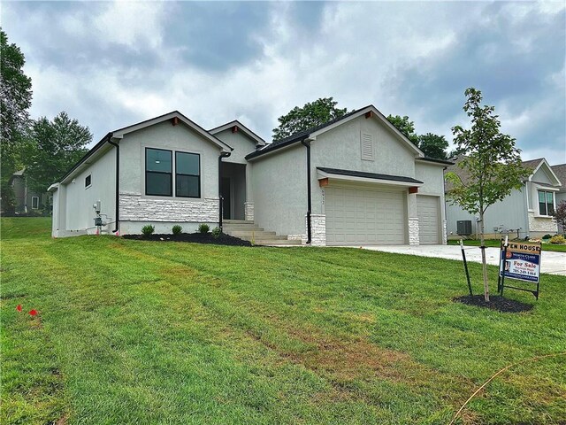 6932 Kenton St, Shawnee, KS 66226 - ranch-style home featuring a garage, stone siding, a front yard, and driveway