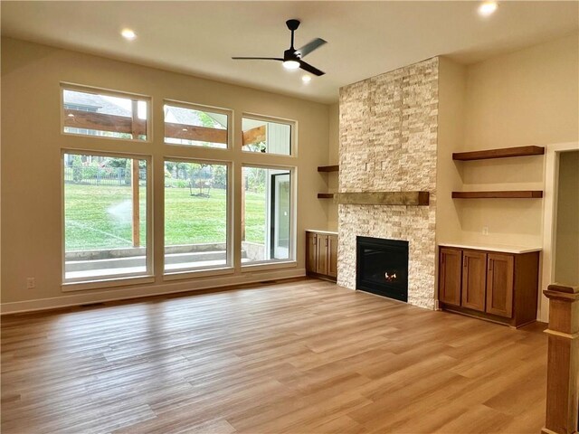 6932 Kenton St, Shawnee, KS 66226 - unfurnished living room featuring light wood-style floors, a fireplace, ceiling fan, and recessed lighting